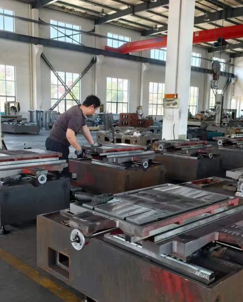 Factory floor with wire EDM machine beds being fitted and inspected before shipment